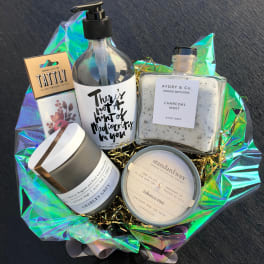 Gift basket with bath products, candle, lotion, and temporary tattoos