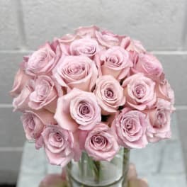 Bouquet of pale pink roses in a clear glass vase