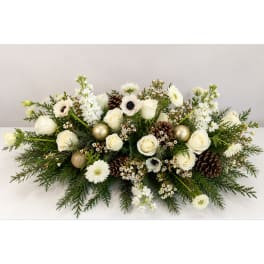 White roses and daisies arranged with pinecones and gold ornaments