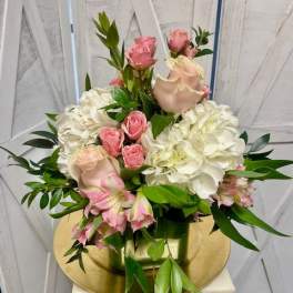 Pink roses and white hydrangeas arranged in a vase