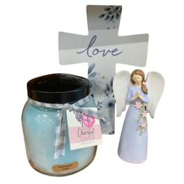 Gift set with a blue candle, angel figurine, and decorative cross sign