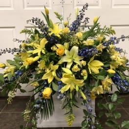 Large yellow and blue floral spray with lilies and roses