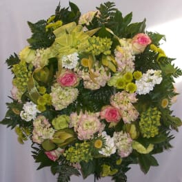 Round floral spray with pink roses, pale hydrangeas, and white blooms
