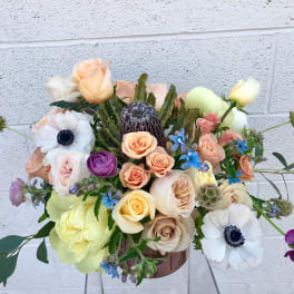 Mixed bouquet of roses and anemones in a vase
