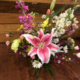 Mixed bouquet with a pink stargazer lily and colorful blooms
