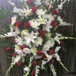 Large standing floral spray with red roses and white lilies