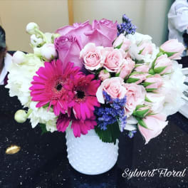 Pink and white bouquet in a white textured vase