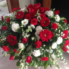 Large red and white floral spray with roses, gerbera daisies, and carnations