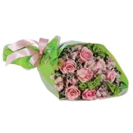 Pink rose bouquet wrapped in green paper with a pink ribbon