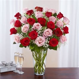 Bouquet of red and pink roses in a clear glass vase