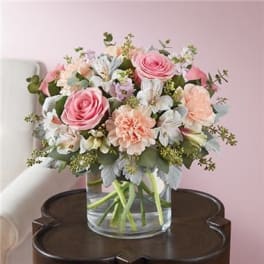 Pink and peach bouquet in a clear glass vase