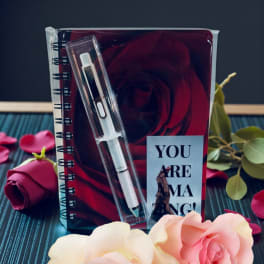 Gift set with a notebook, pen, and roses