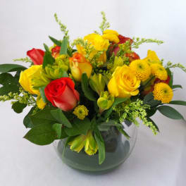 Bouquet of red and yellow roses in a glass vase