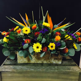 Bright mixed floral arrangement in a rectangular container