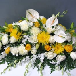 White and yellow floral arrangement with roses and anthuriums