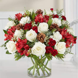 Red and white floral arrangement in a clear glass vase