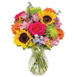 Mixed bouquet with sunflowers, a pink rose, and a glass vase