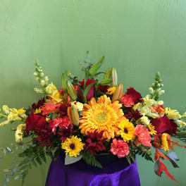 Colorful mixed flower arrangement with lilies, gerbera daisies, and roses