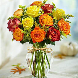Bouquet of multicolored roses in a clear glass vase