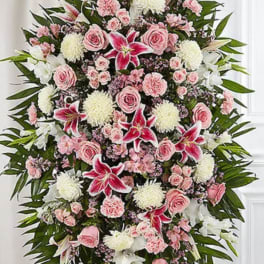 Large standing floral spray with pink and white flowers on an easel