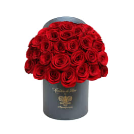 Red roses arranged in a black cylindrical box
