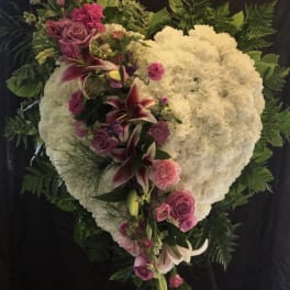 Heart-shaped white floral spray with pink roses and lilies