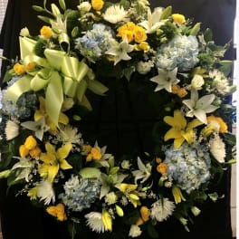 Large floral wreath with yellow, white, and blue flowers