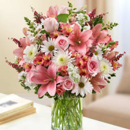 Pink and white mixed bouquet in a clear glass vase