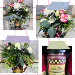 Floral arrangement in a candle jar with white and pink blooms