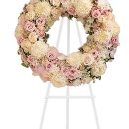 Pastel floral wreath on a white stand