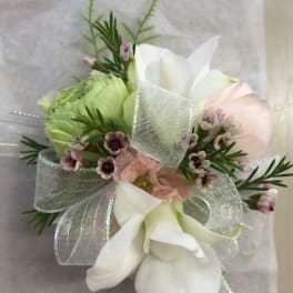 Small bouquet with white calla lilies, pale pink blooms, and a silver ribbon.