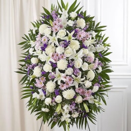Large standing floral spray with white, pink, and purple flowers