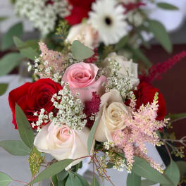 Bouquet of red, pink, and white roses with airy filler flowers