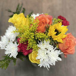 Mixed bouquet of roses, chrysanthemums, and carnations in bright colors