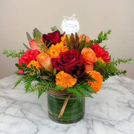 Bouquet of red and orange flowers in a glass vase
