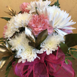 Pink and white chrysanthemum bouquet with a bright ribbon in a vase