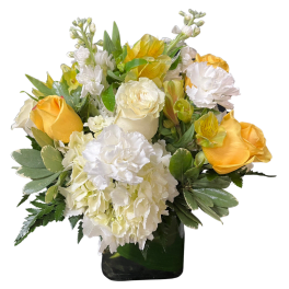 Yellow and white floral arrangement in a glass vase