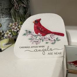 Decorative plaque with a red cardinal and floral accents