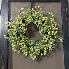 Green berry wreath on a dark framed background