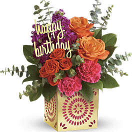 Birthday flower arrangement with roses, carnations, and a "happy birthday" sign in a gift box