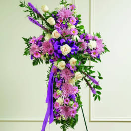 Purple and white floral standing cross on an easel