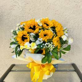 Bouquet of sunflowers with white flowers and a yellow ribbon