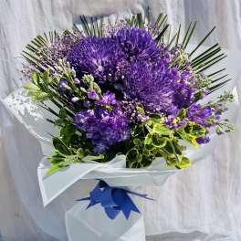 Purple bouquet with hydrangeas and a blue ribbon