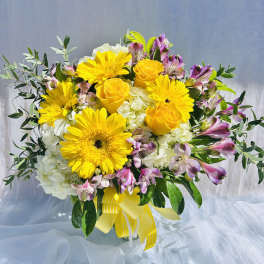 Yellow roses and gerbera daisies with white hydrangeas and pink alstroemeria