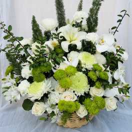 White and green floral basket arrangement with roses, orchids, and chrysanthemums