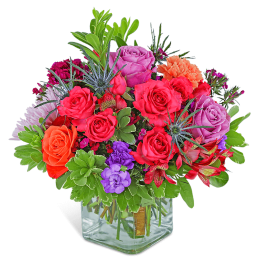 Colorful mixed bouquet in a clear square vase