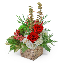 Red roses and white flowers in a bark-textured square container