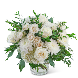 White roses and chrysanthemums in a clear glass vase