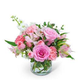 Pink roses and carnations in a clear glass vase