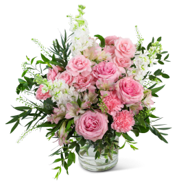 Pink roses and carnations in a clear glass vase